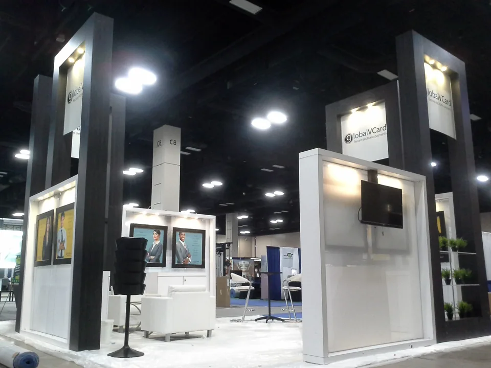 GlobalVCard exhibit with tall dark towers and white lounge