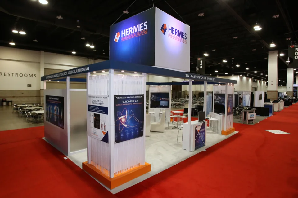 Hermes Medical Solutions exhibit seen from the aisle on red carpet