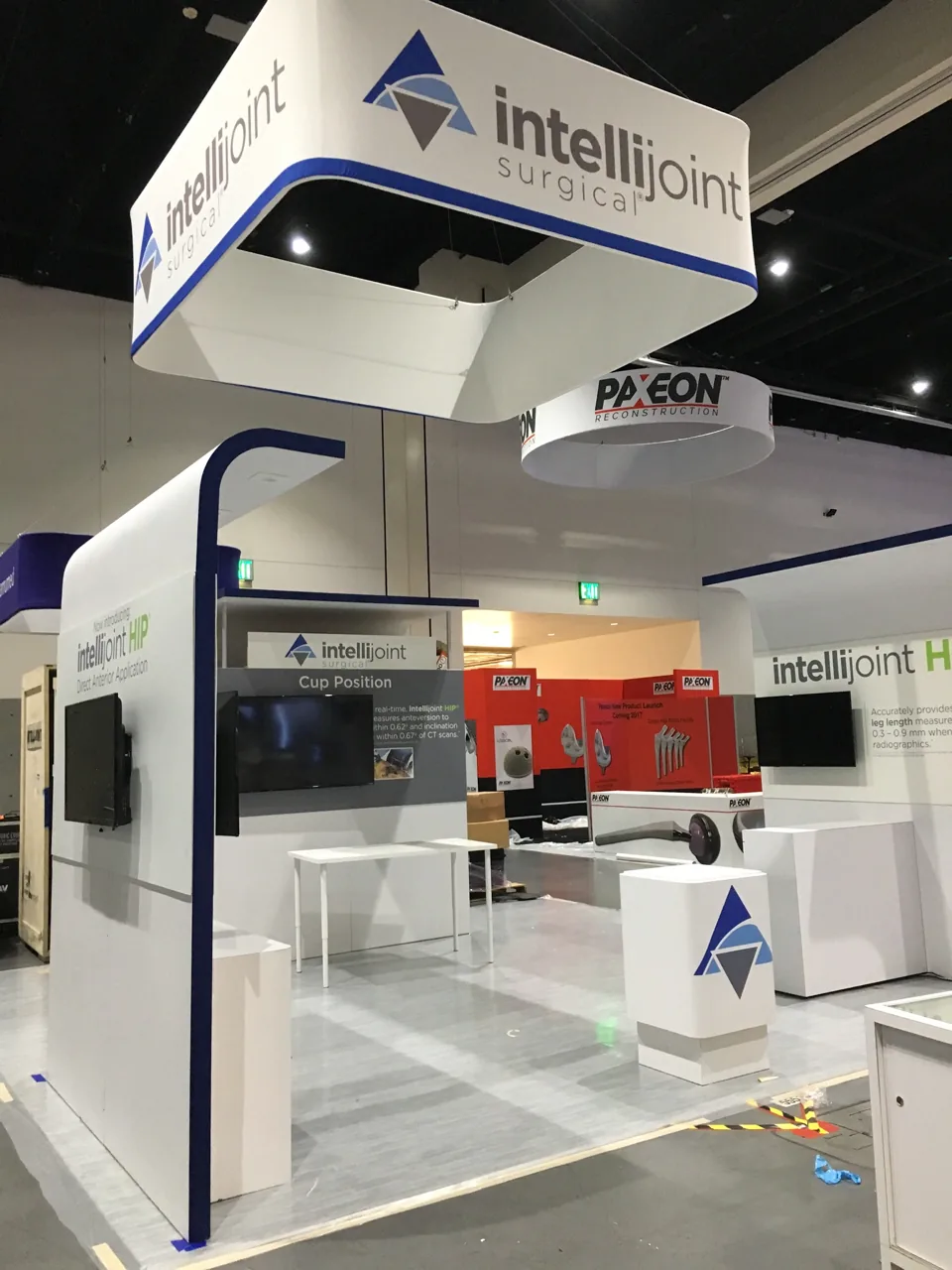 Intellijoint Surgical exhibit with hanging sign and curved walls