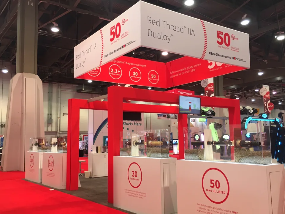 NOV Red Thread exhibit with a red overhead frame and white counters