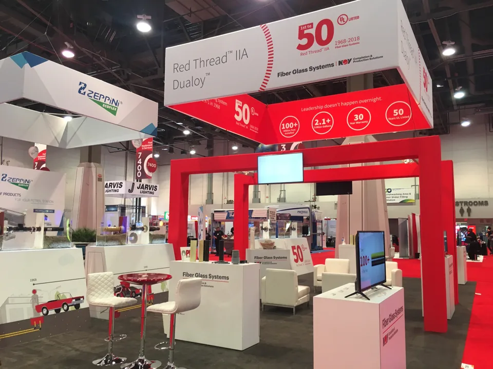 NOV Fiber Glass Systems exhibit on red carpet with white lounge