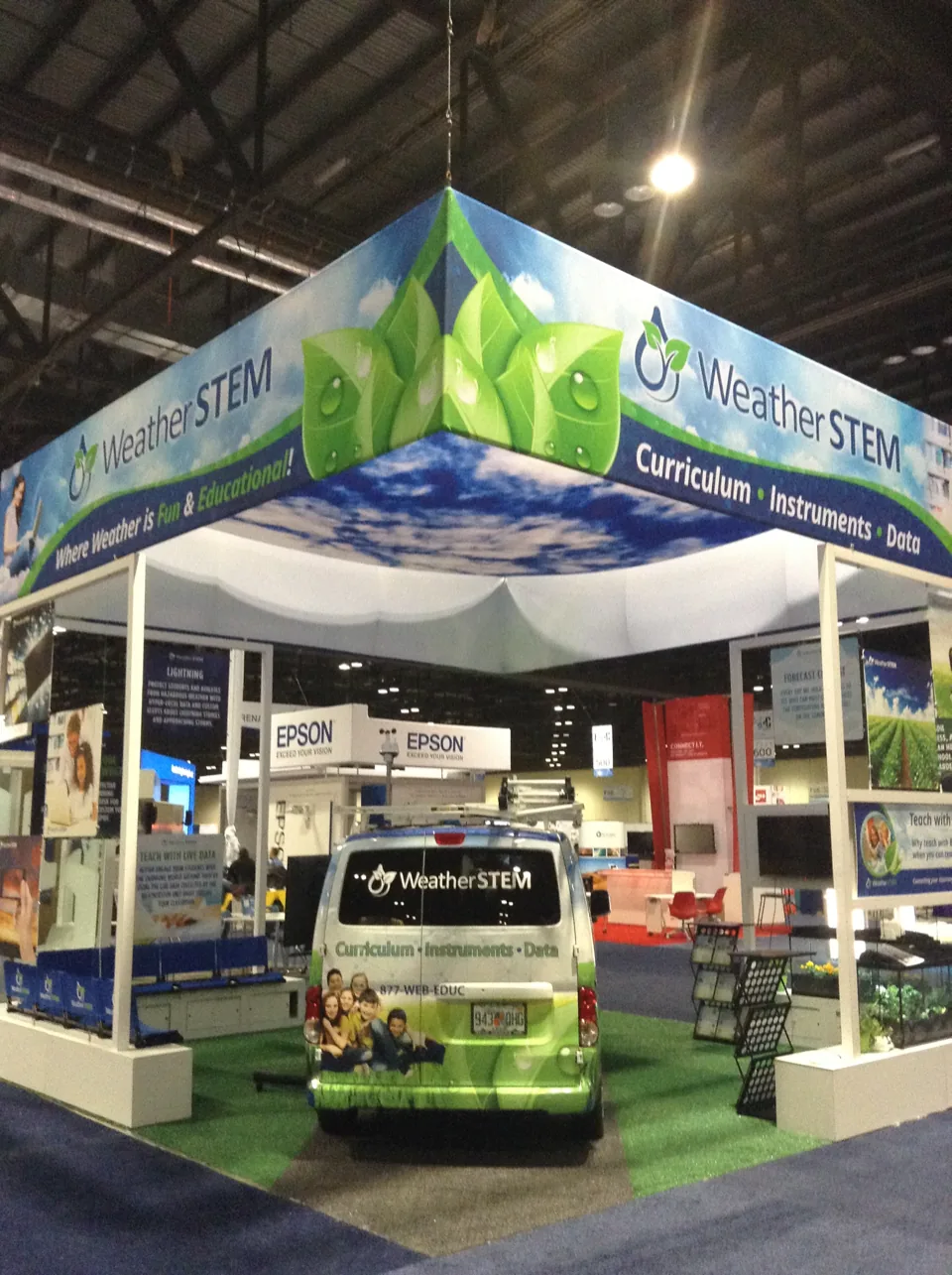 WeatherSTEM exhibit with fabric canopy and branded van
