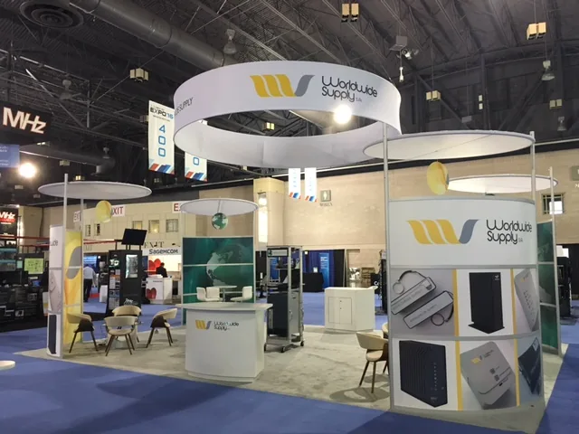Worldwide Supply exhibit with a hanging ring sign and product graphic column